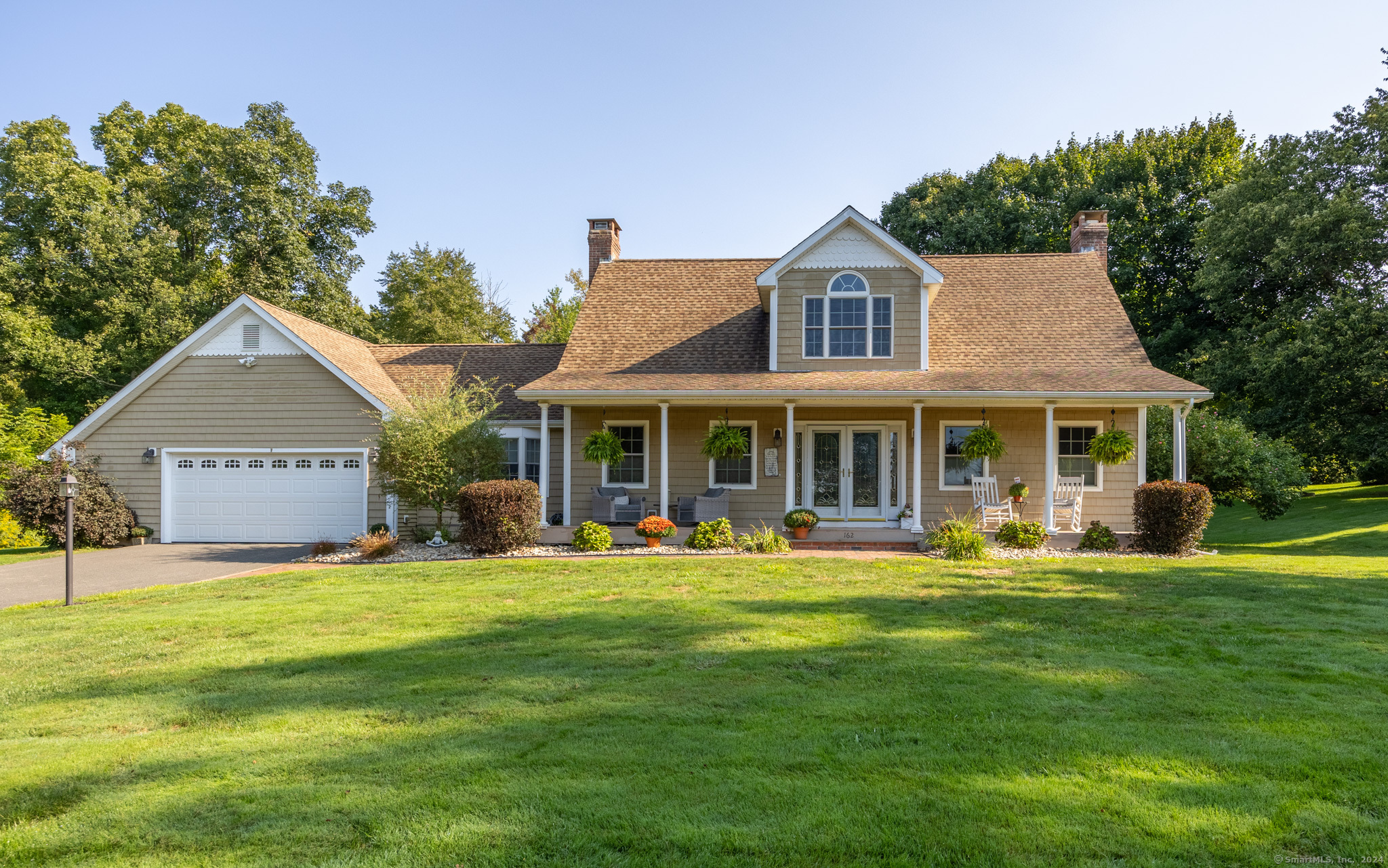 a front view of a house with a garden