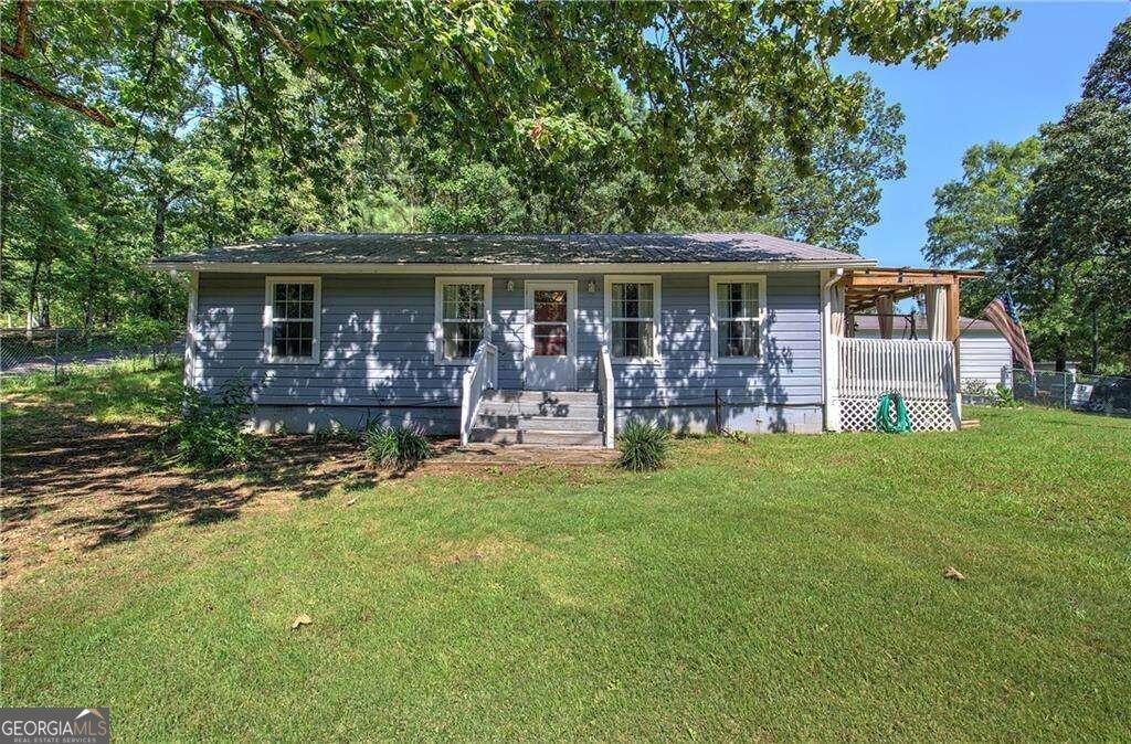 a front view of house with yard and outdoor seating