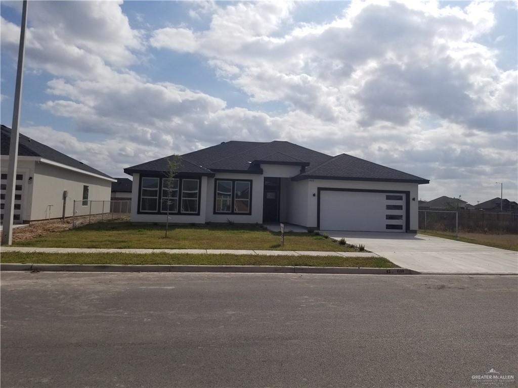 a view of a house next to a big yard