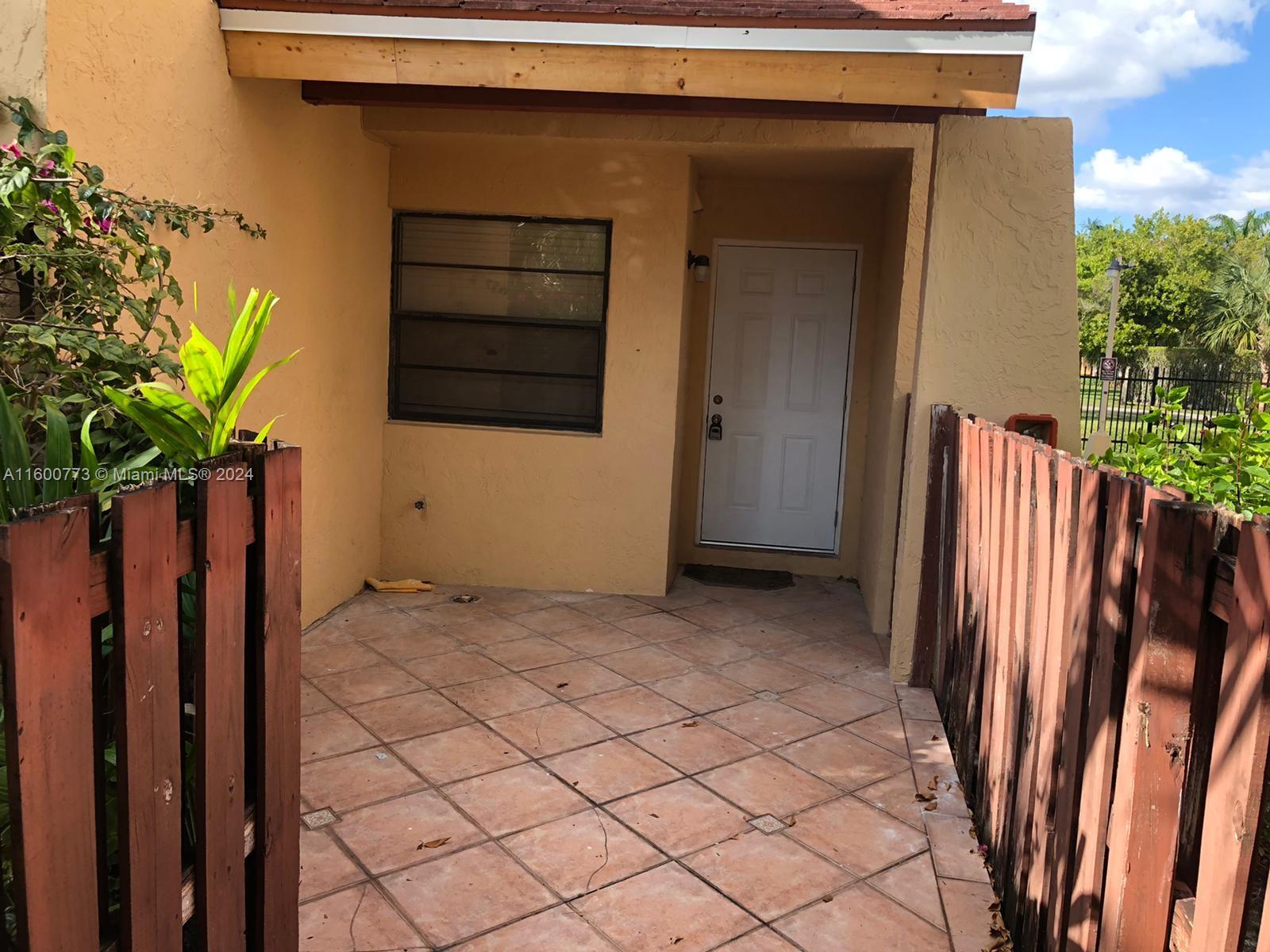 a view of a house with backyard and a potted plant