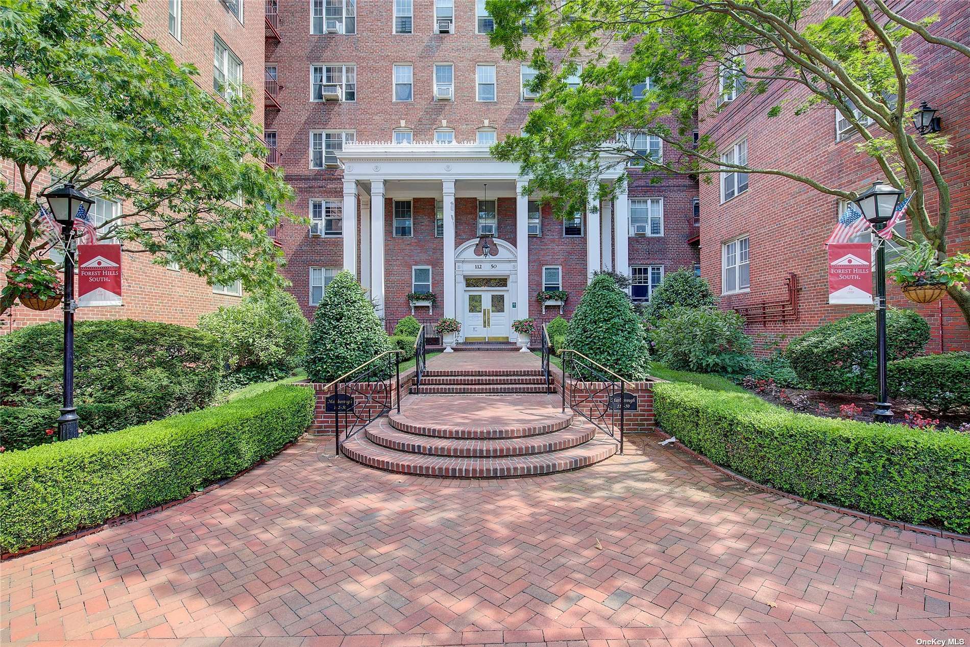 a front view of a house with a yard and fountain