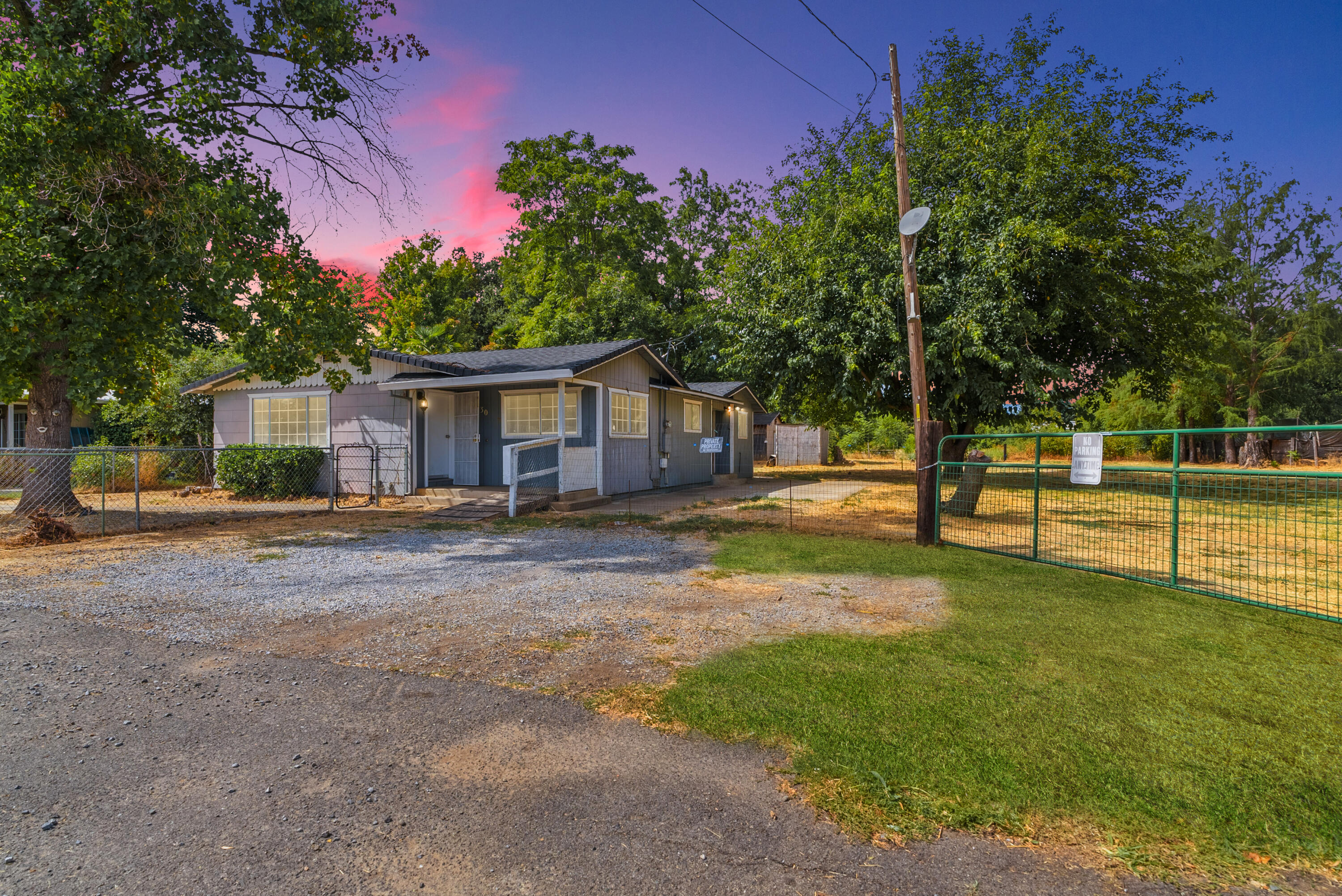 a view of a house with backyard and a tree