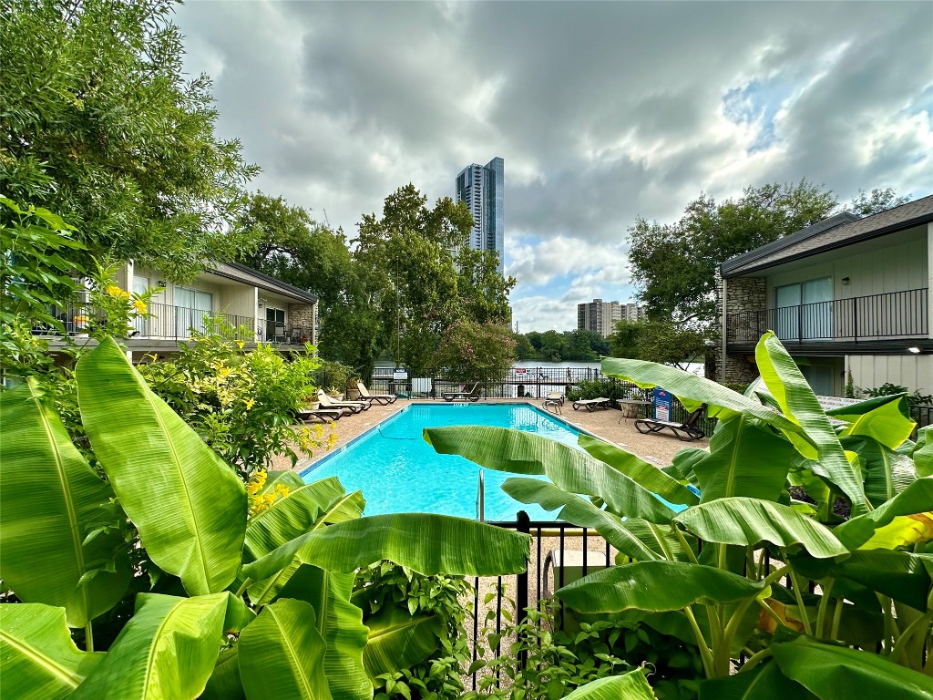 a view of a swimming pool with a patio and a garden