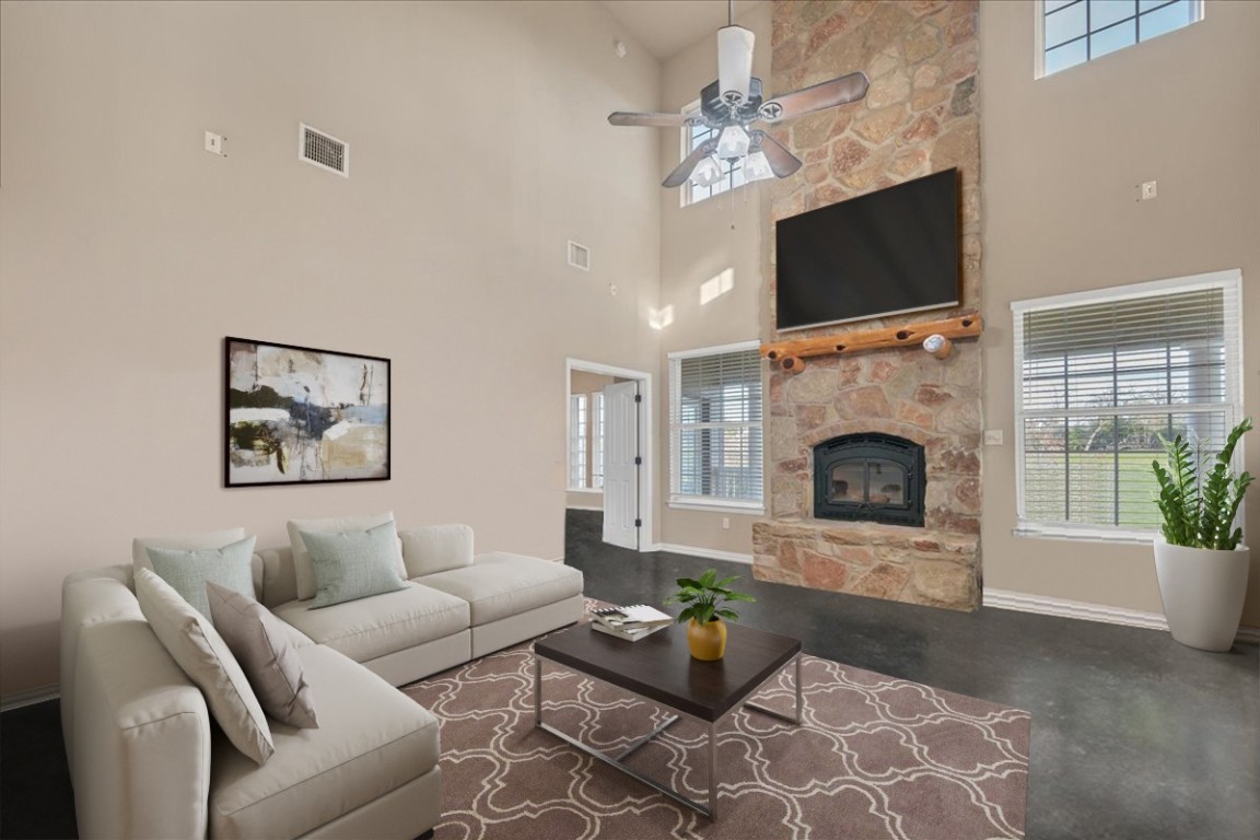 a living room with furniture a fireplace and a flat screen tv