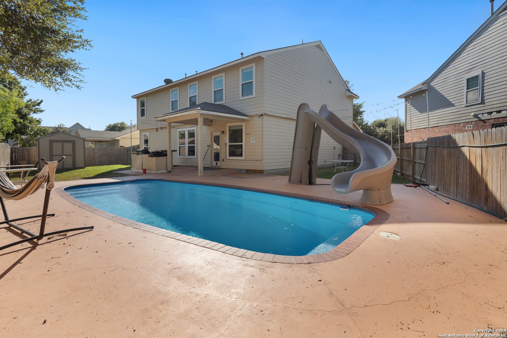 a front view of house with swimming pool yard fire pit and outdoor seating