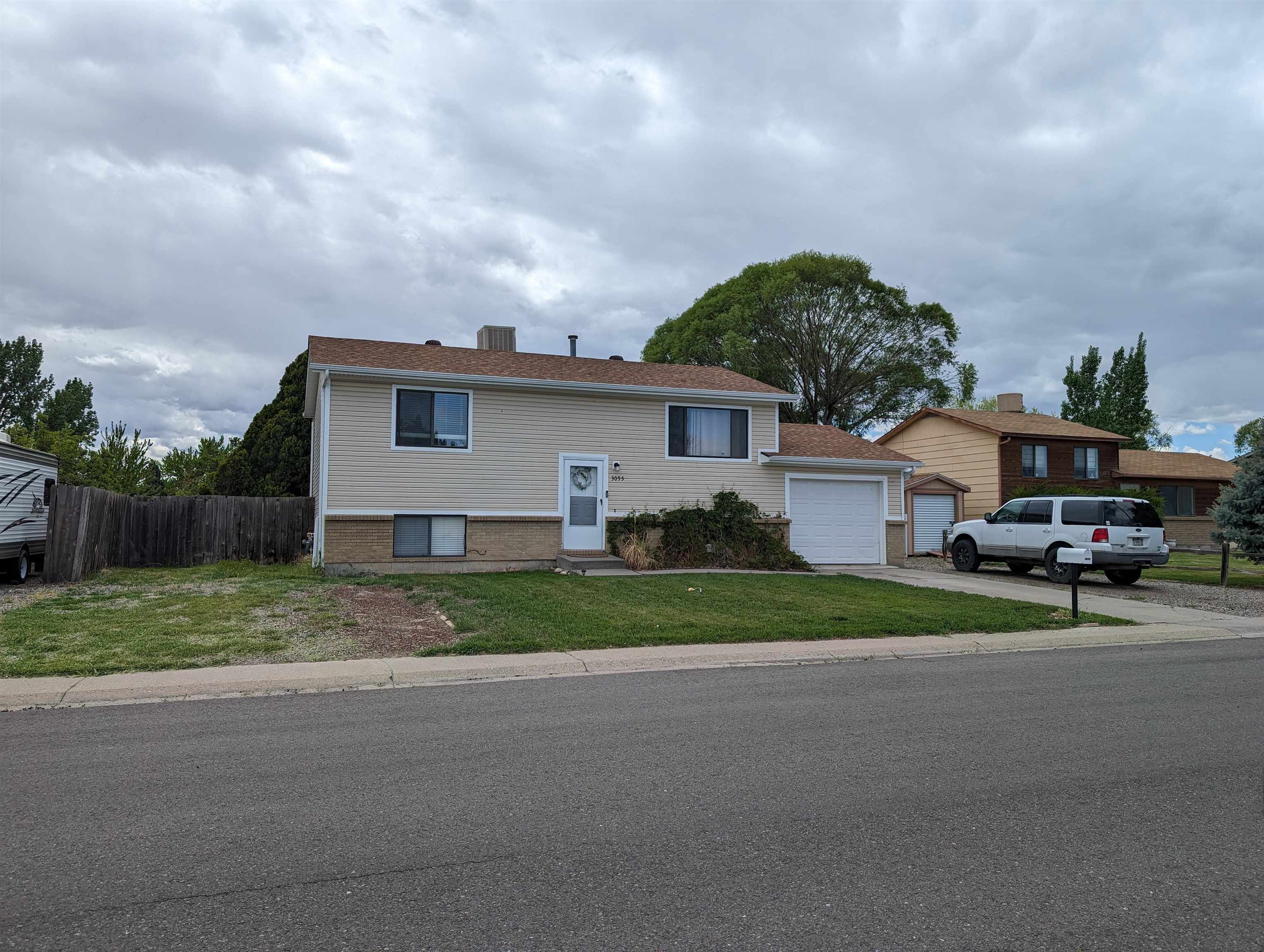 a view of a house next to a yard and road