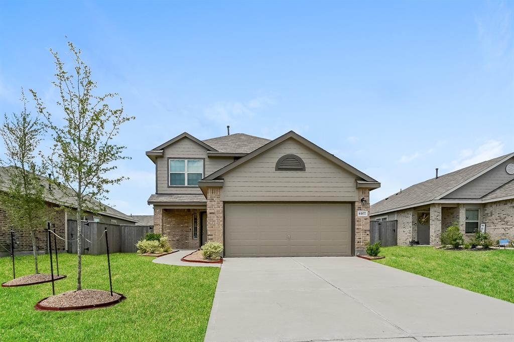 a front view of a house with a yard and garage