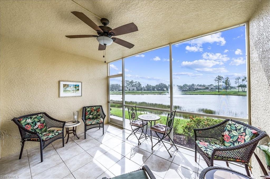 Sunroom with a water view and ceiling fan