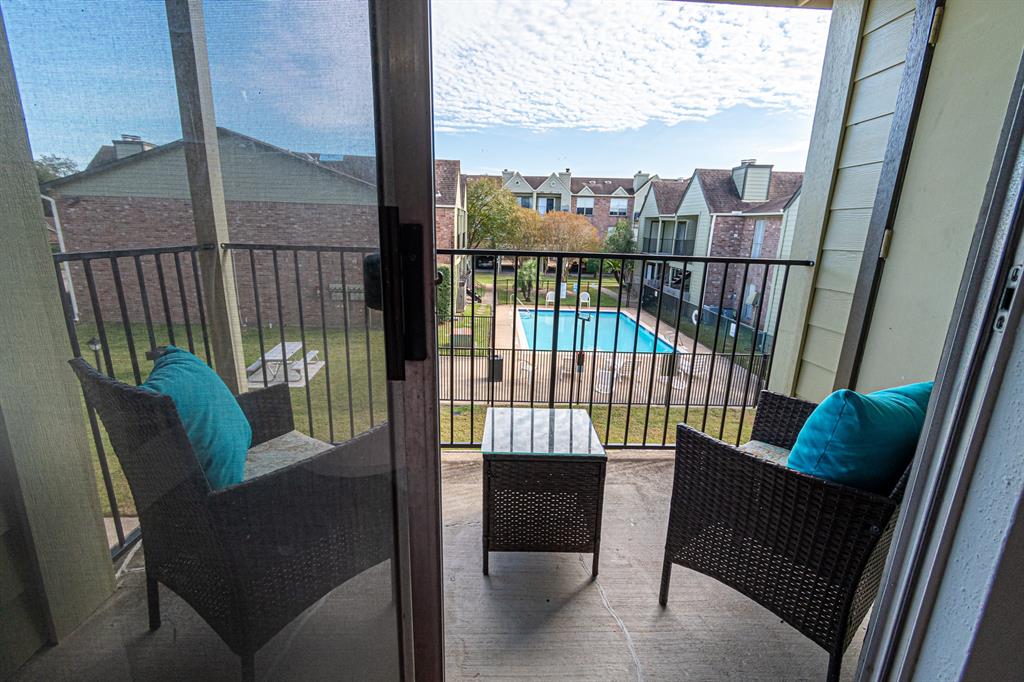 a view of a balcony with furniture