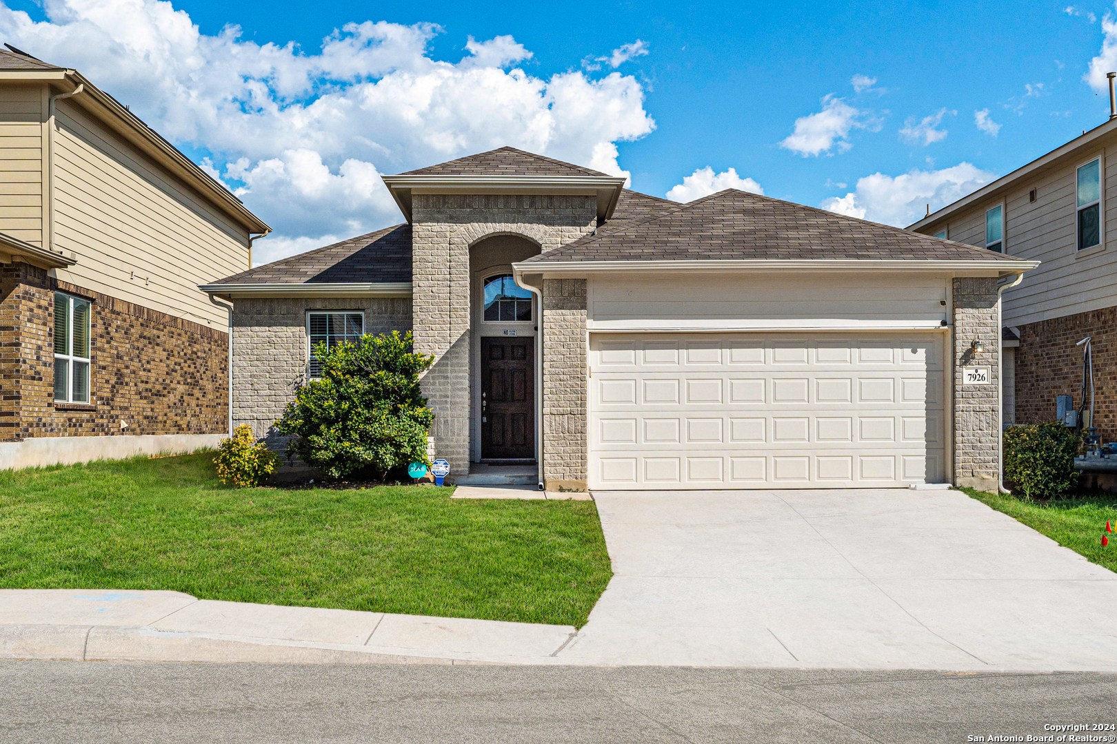 a front view of a house with a yard