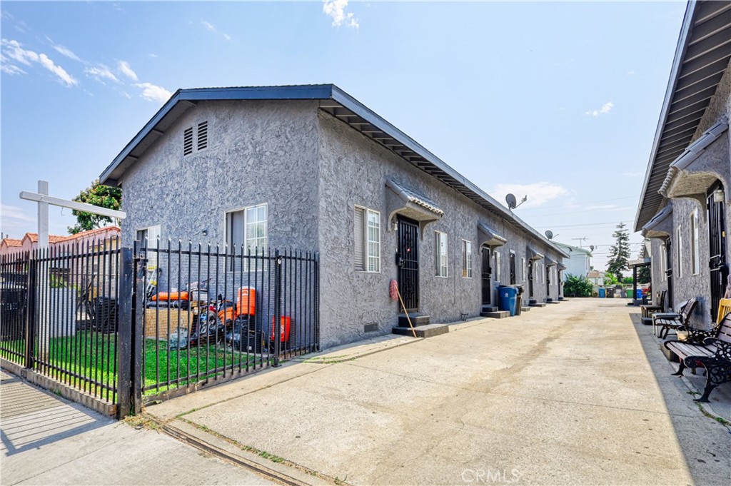 a view of a house with wooden fence