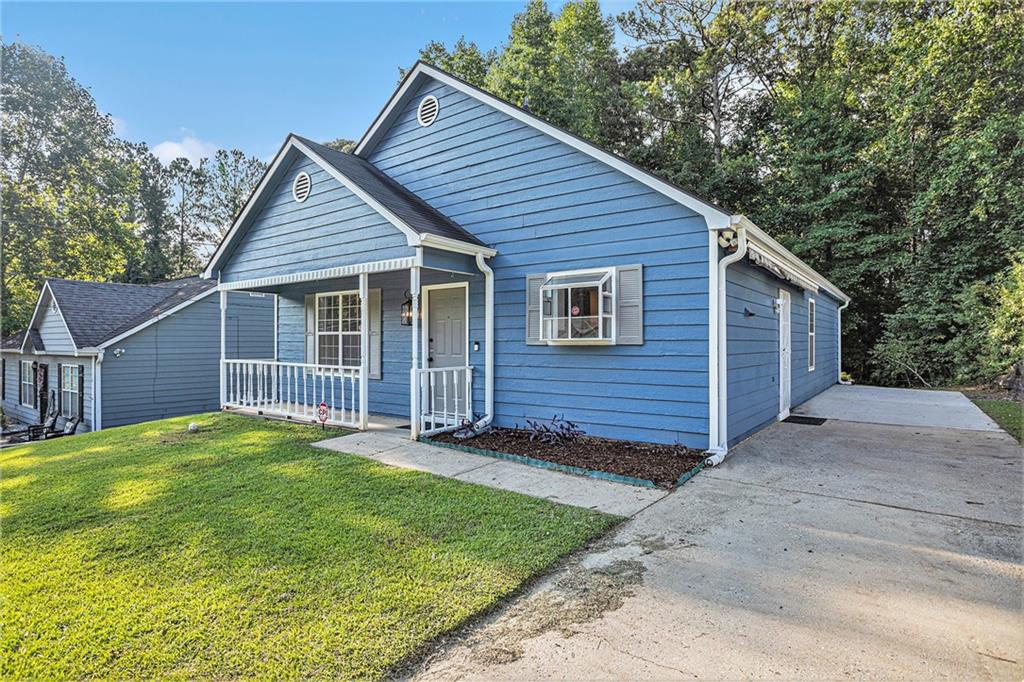 a view of a house with a yard and fence