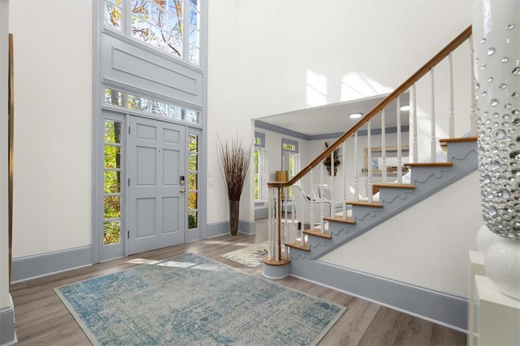 a view of entryway and hall with wooden floor