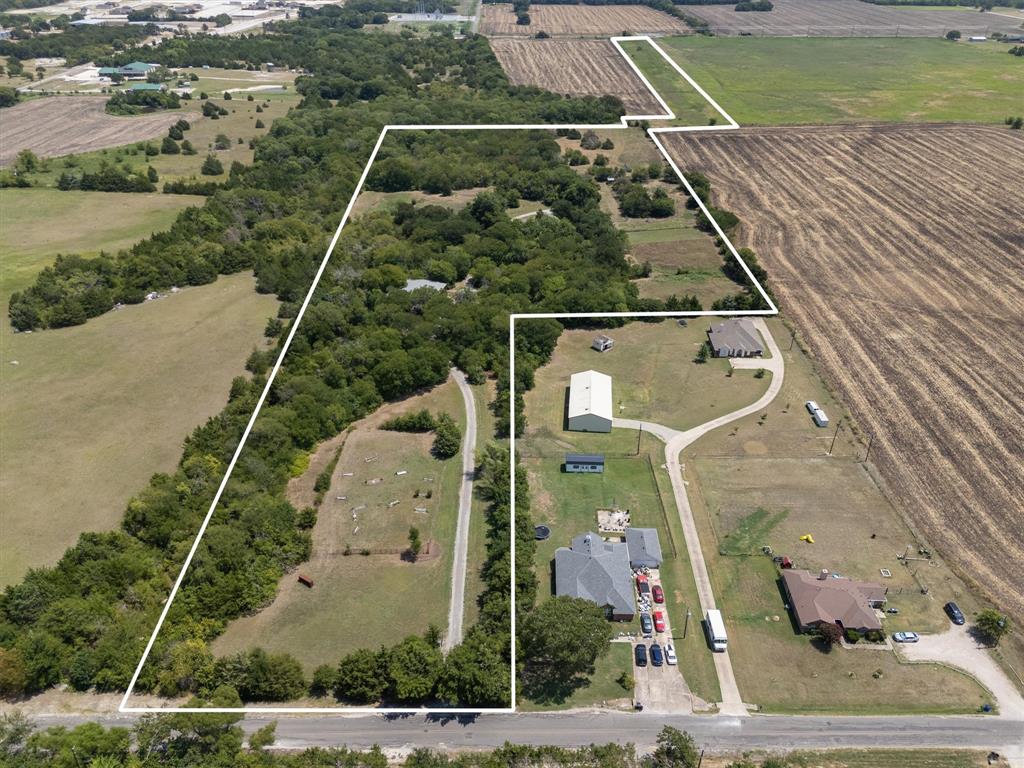 an aerial view of a house with a yard