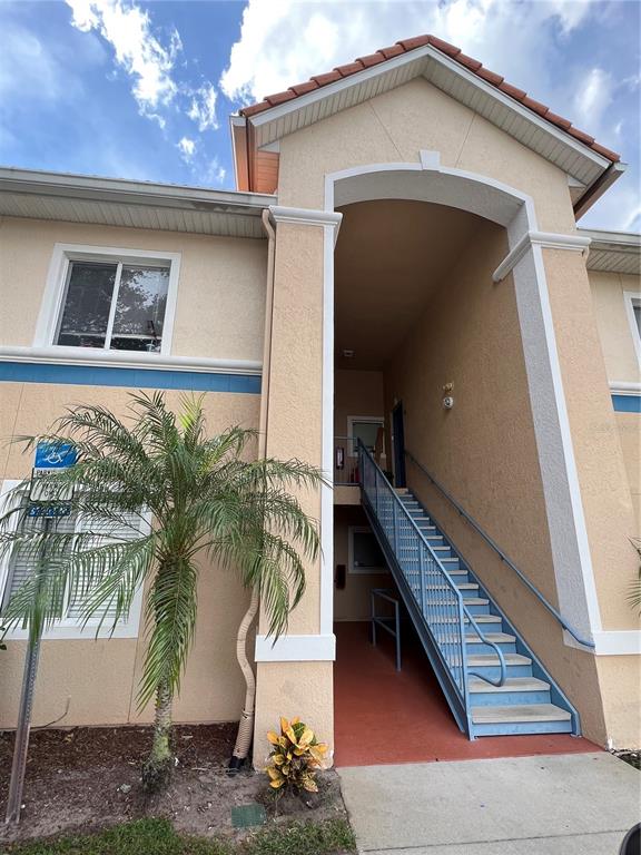 a view of a house with a yard and balcony