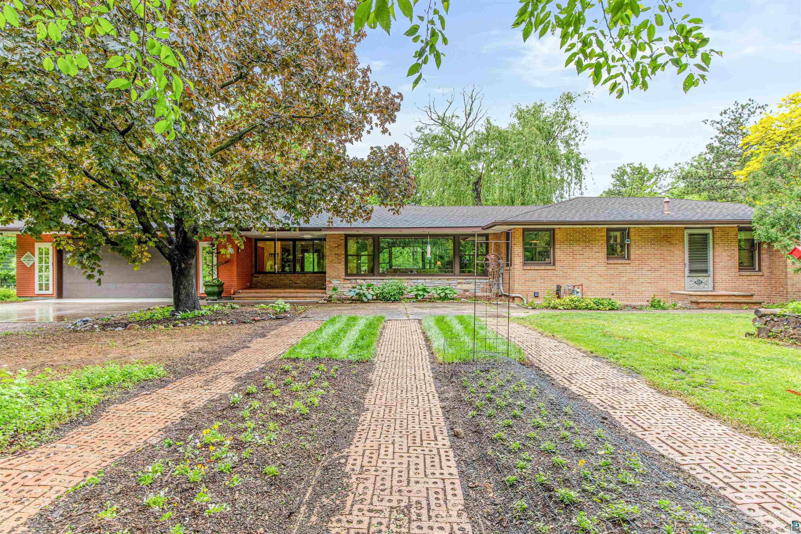 Single story home with a garage and a front yard