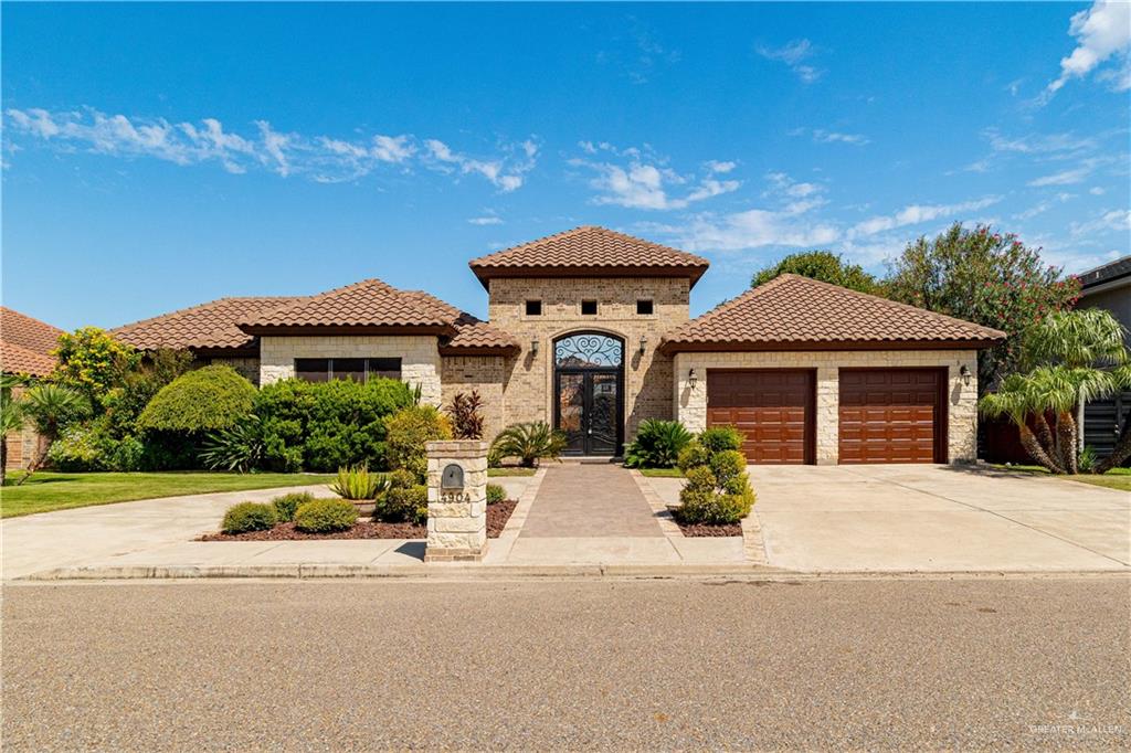 Mediterranean / spanish home with a garage