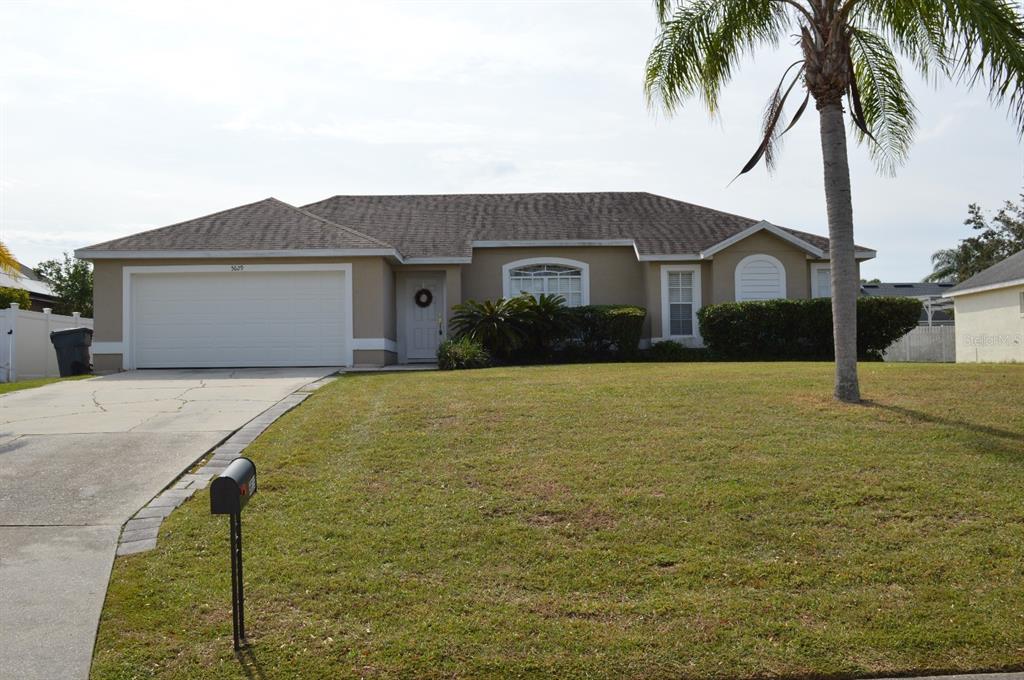 a front view of house with yard and garage