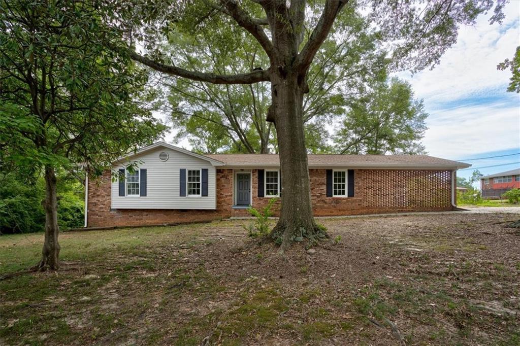 a house that has a tree in front of it