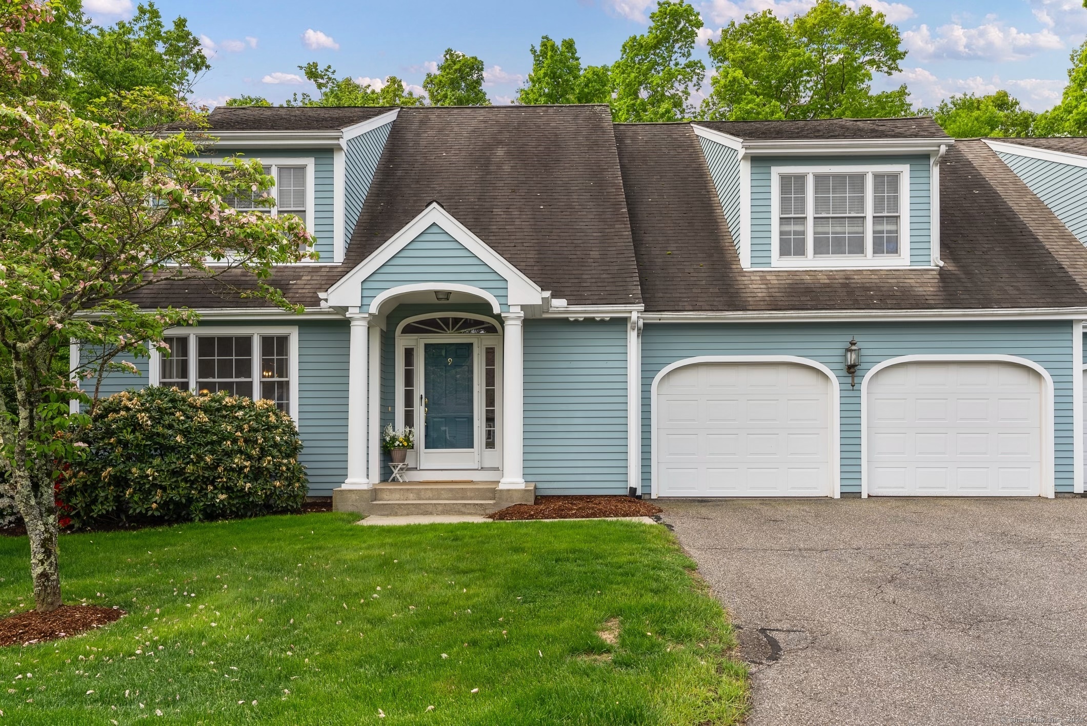 a front view of a house with a garden