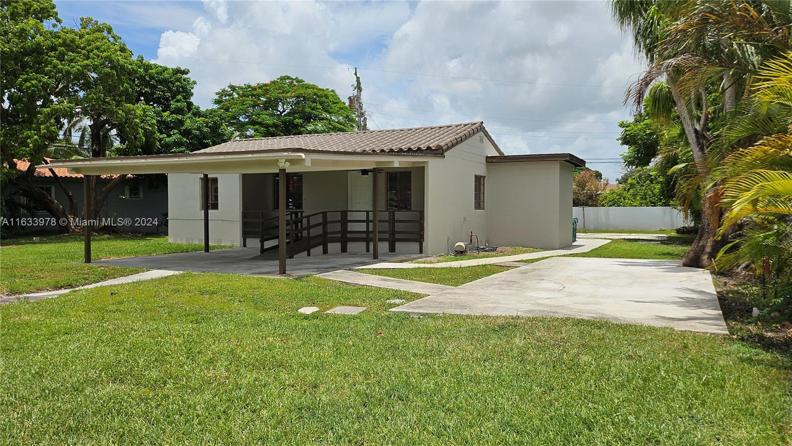 a front view of house with yard and outdoor seating