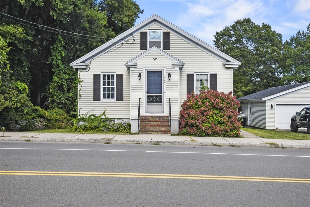 a front view of a house with a garden and garage