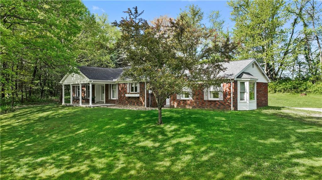 a front view of a house with yard and green space