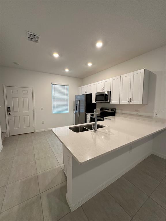 a kitchen with a sink a stove and cabinets