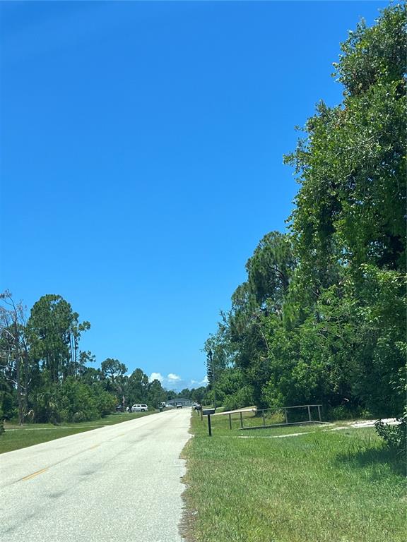 a view of a park with a trees in the background