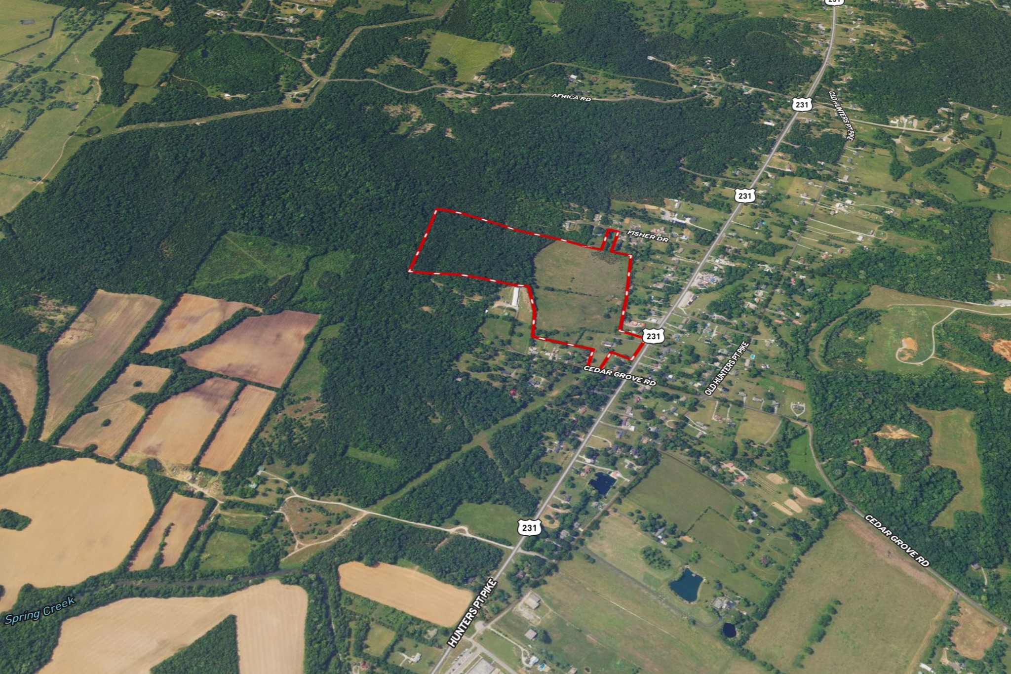 an aerial view of a house with a yard lake lake and mountain view in back