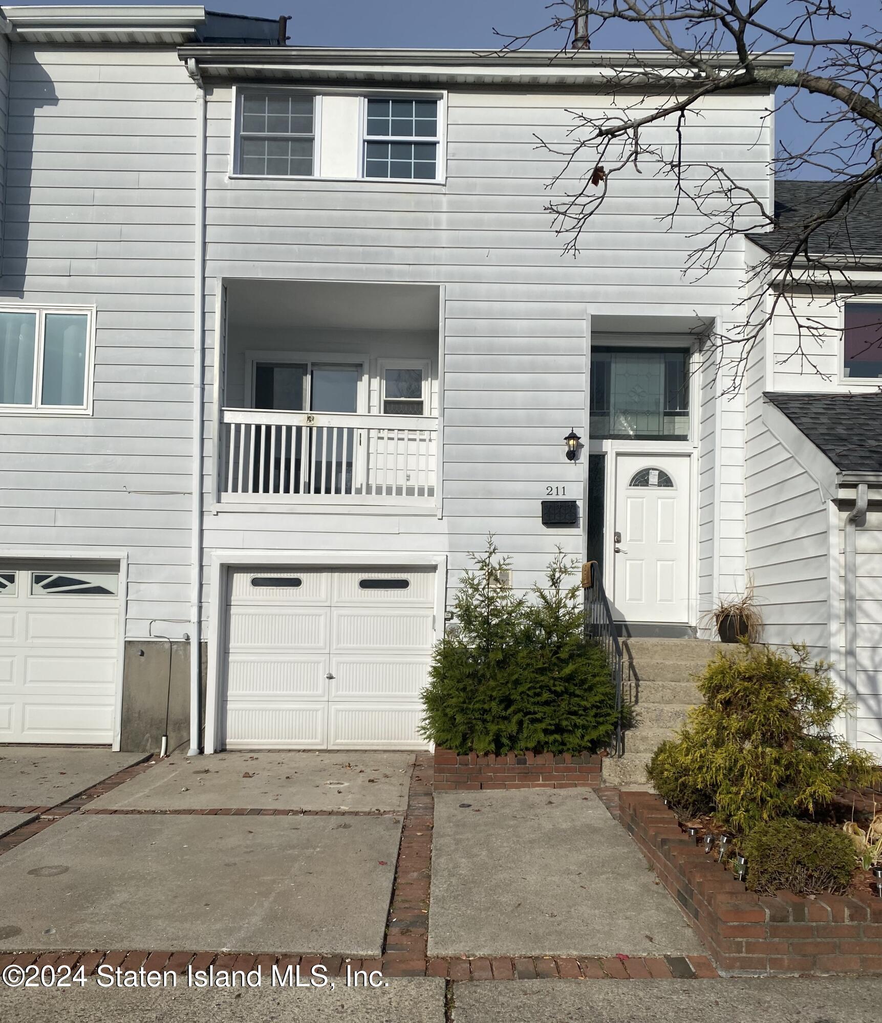 a front view of a house with garage