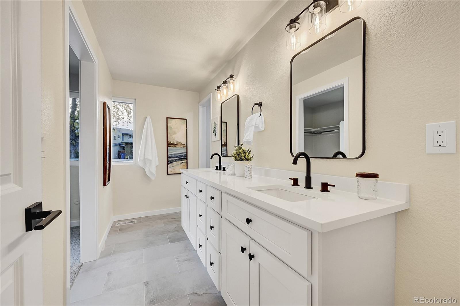 a bathroom with a double vanity sink and mirror