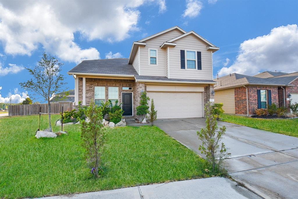 a front view of a house with a yard and garage