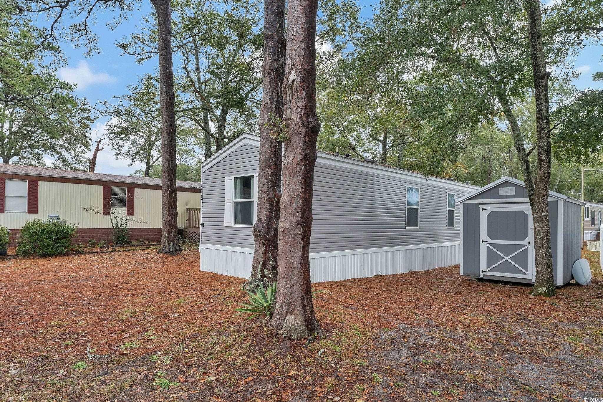 View of side of property with a storage unit