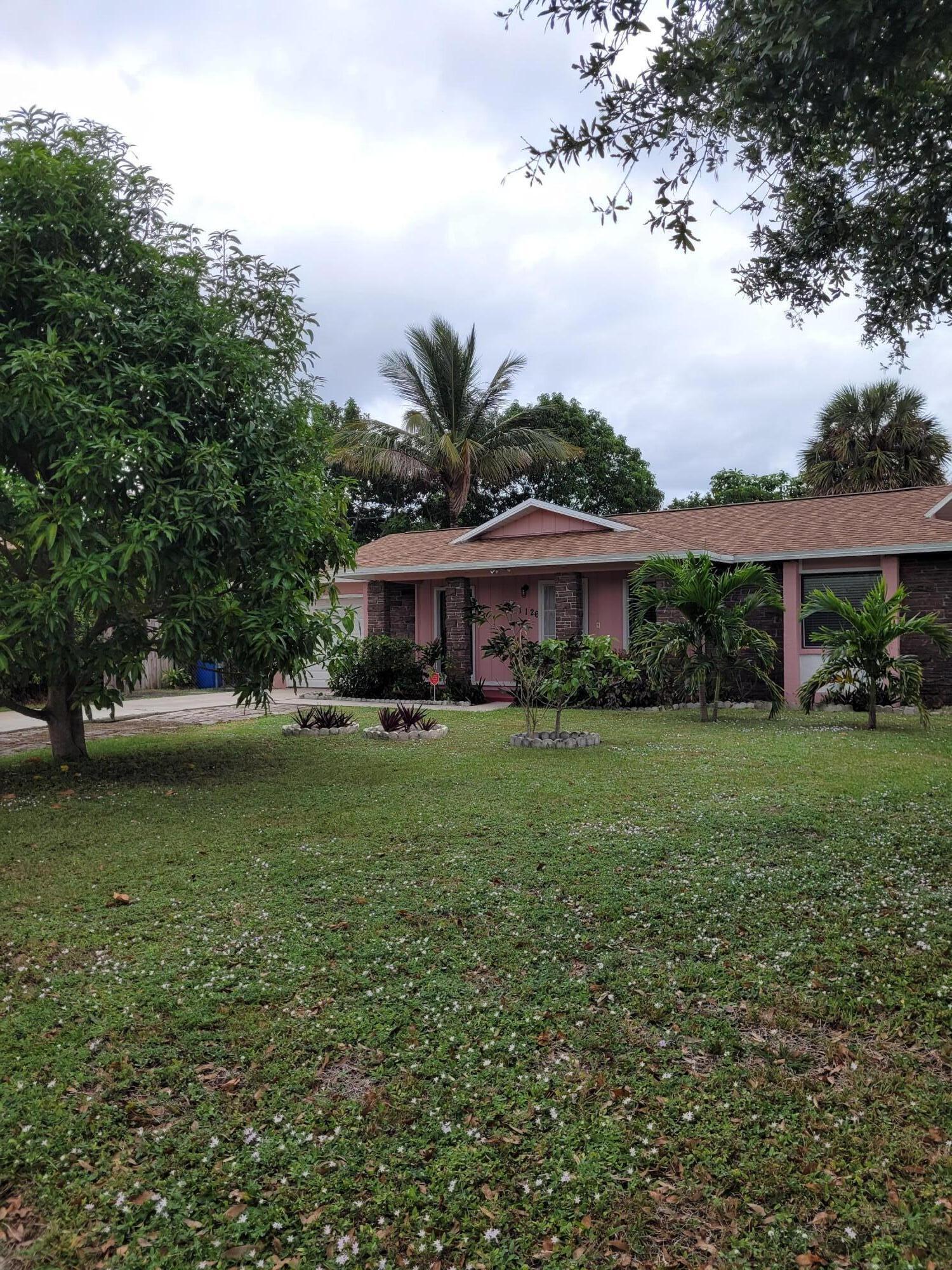 a front view of house with yard and green space