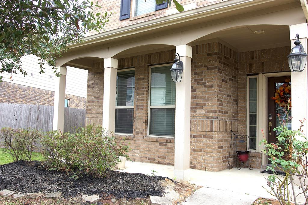 a view of a brick house with potted plants