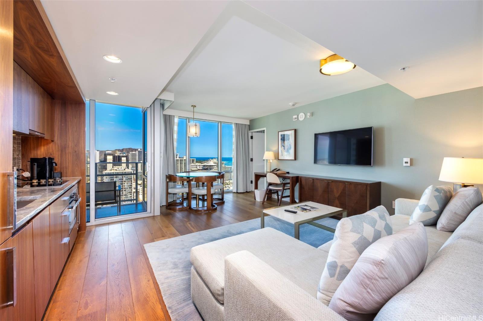 a living room with furniture and a wooden floor