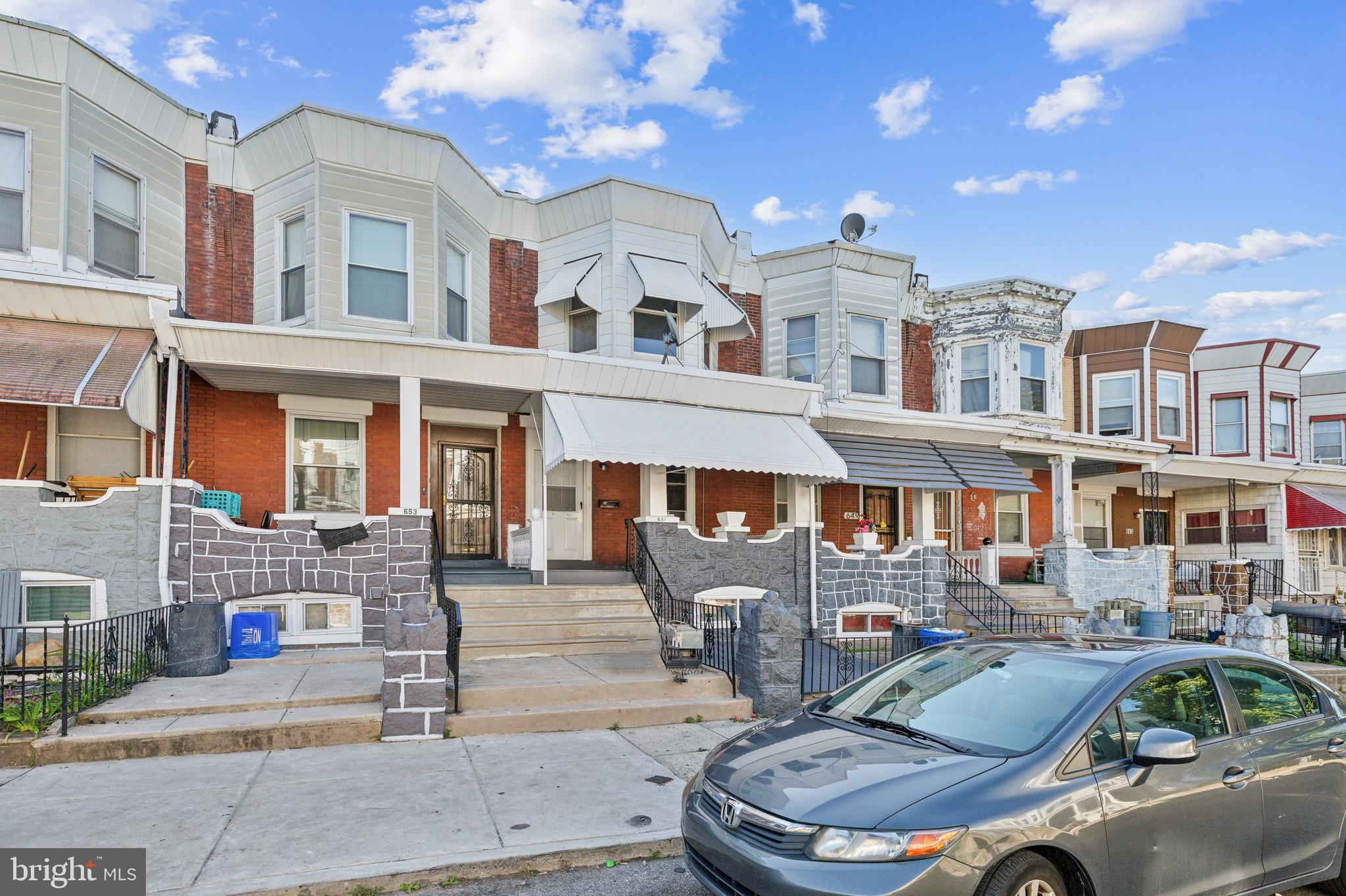 a front view of multiple houses with outdoor seating