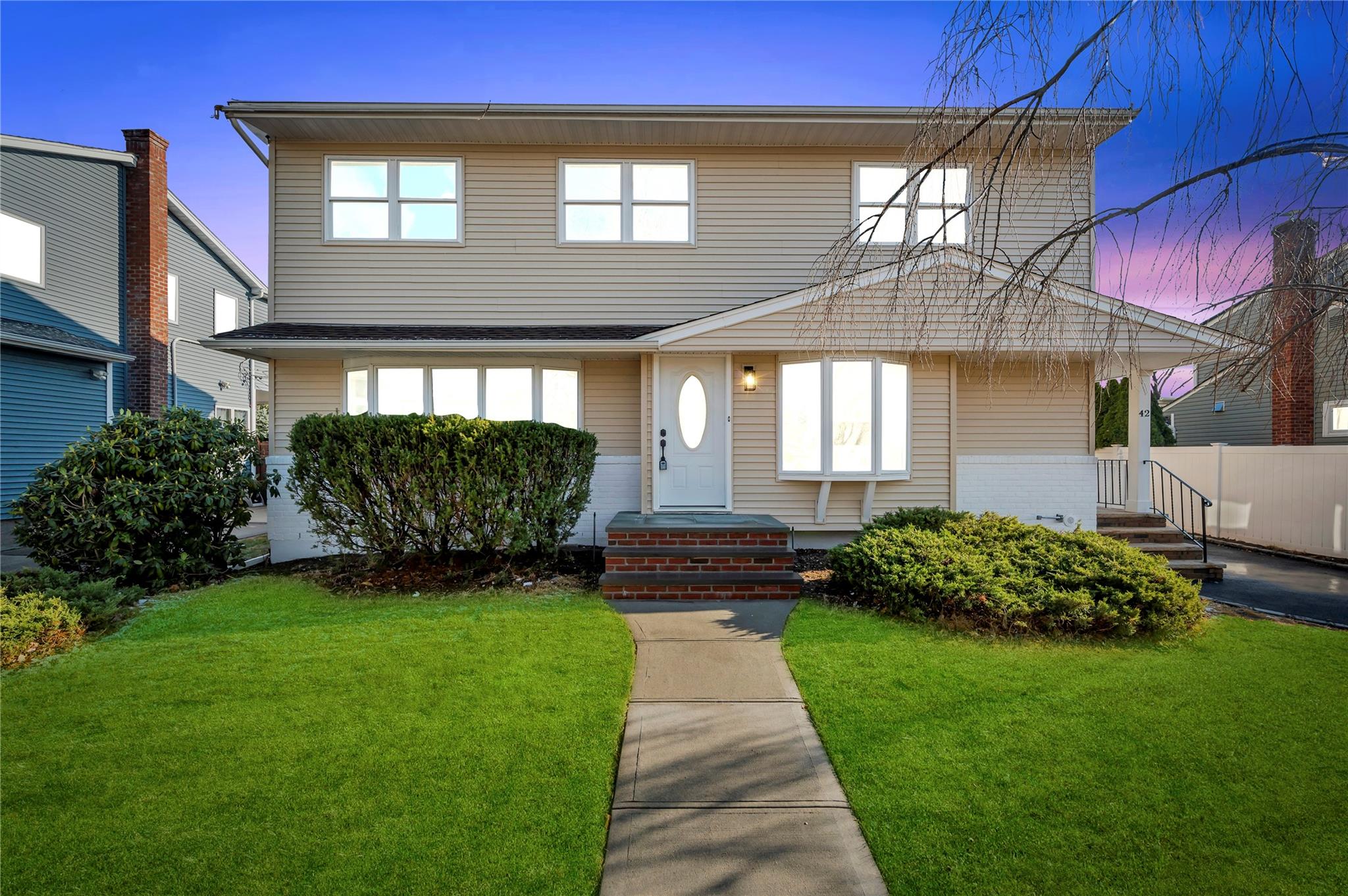 View of front of property with a yard