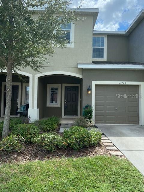 a front view of a house with a yard and garage