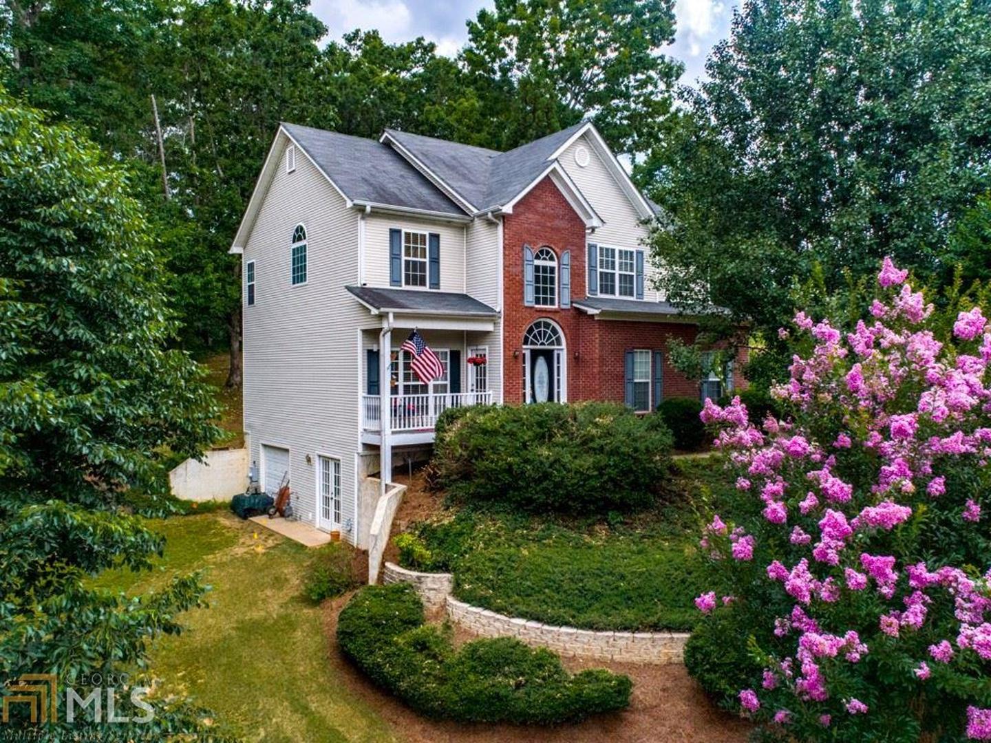 a view of a house with a yard and garden