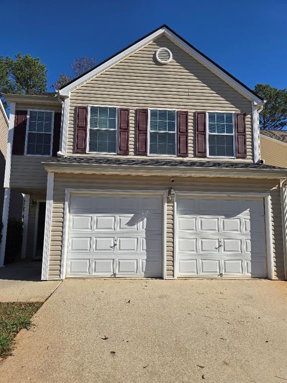 a front view of a house with a garage