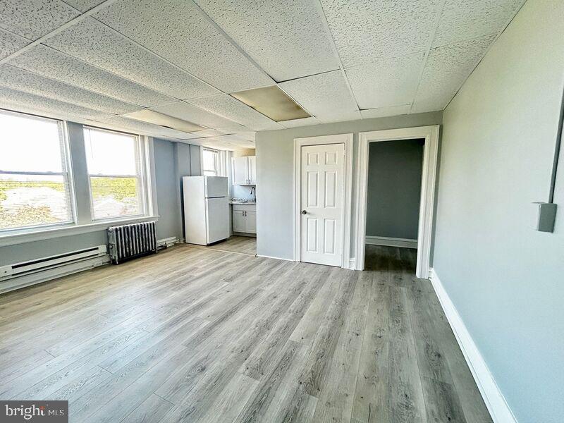 an empty room with a fireplace and windows