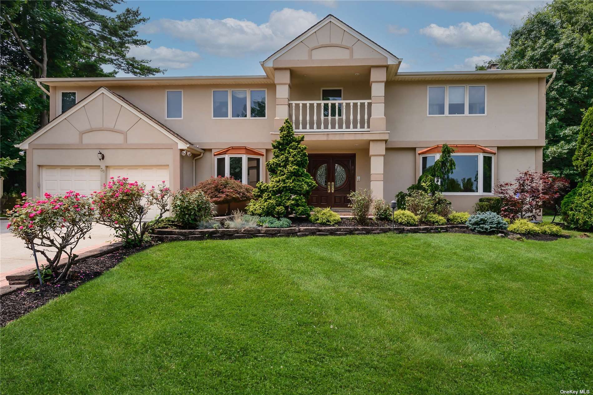 a front view of a house with a garden