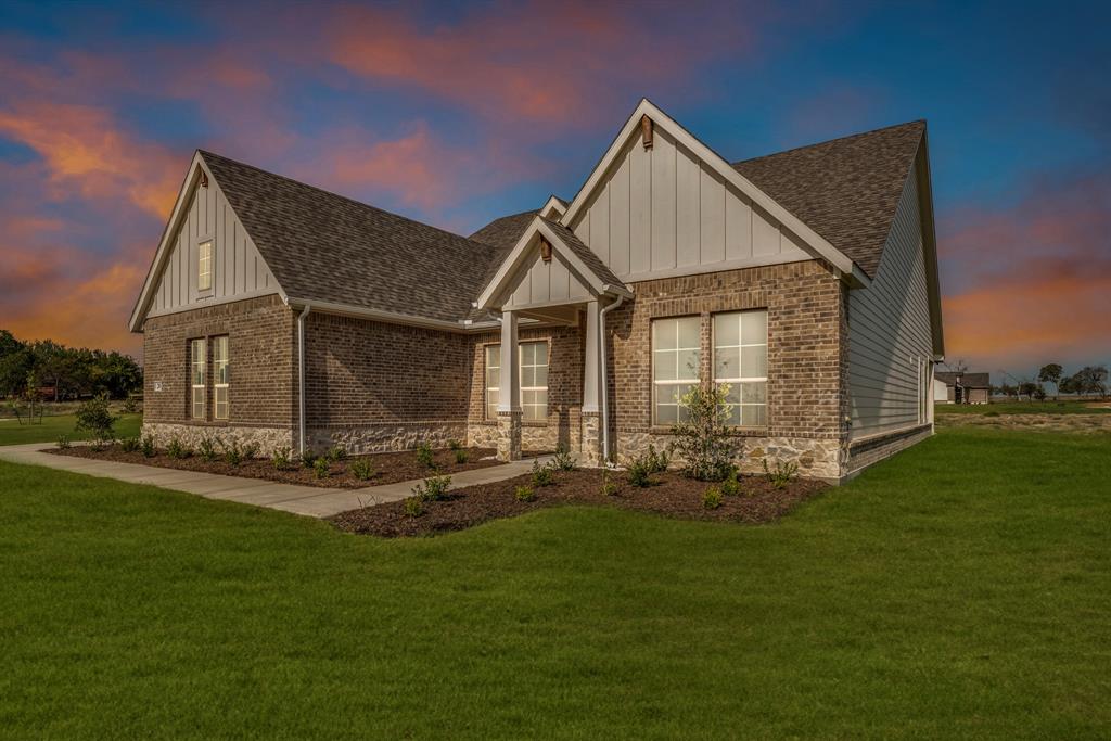 a front view of a house with a yard and patio