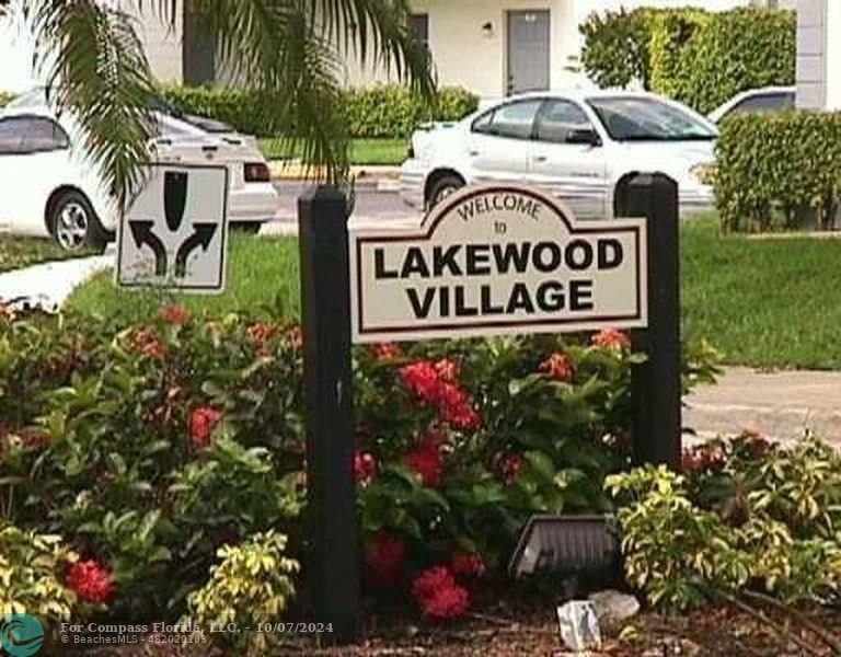 a sign that is sitting in front of flowers