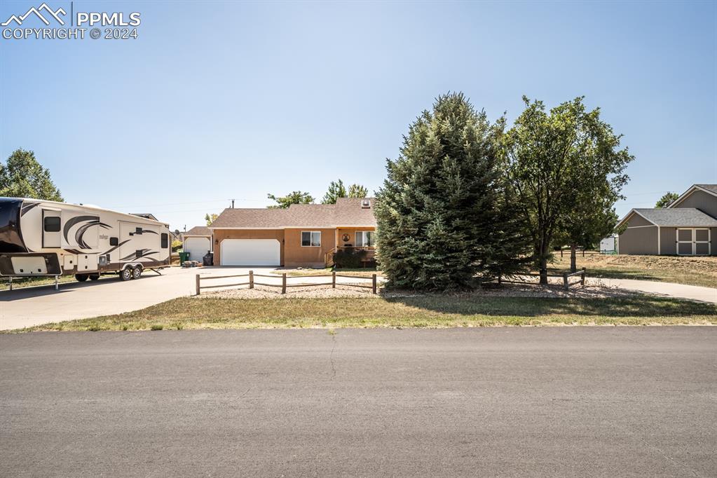 a view of a house with a yard and garage