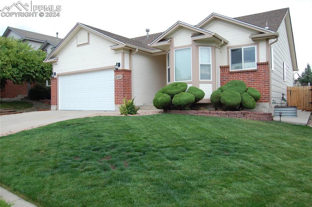 a view of a house with a big yard and potted plants