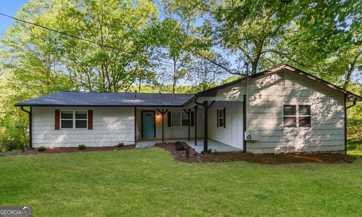 a front view of house with yard and porch