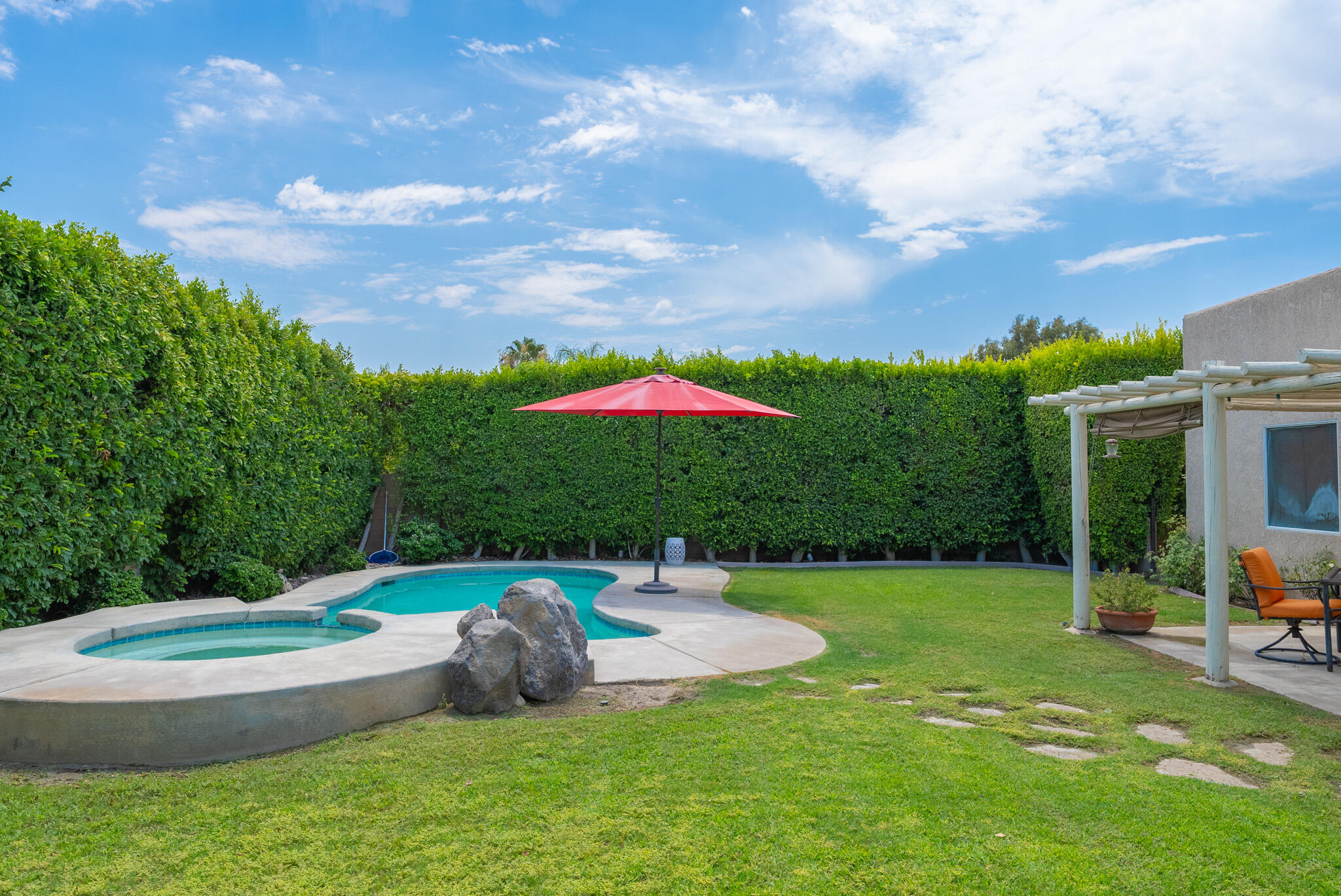 a backyard of a house with table and chairs